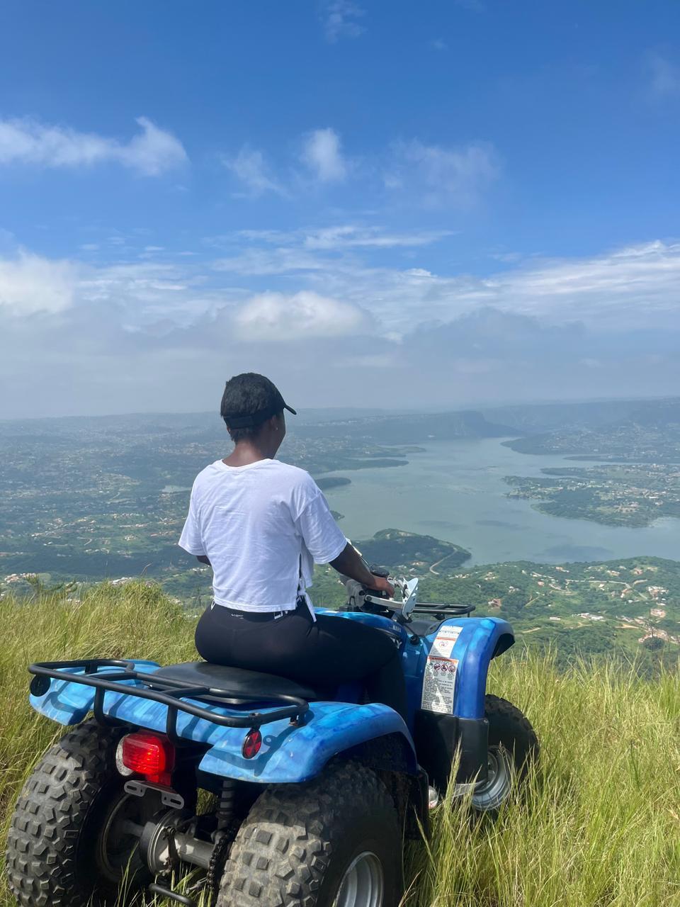 A rider enjoying a scenic view of the dam from a mountain top